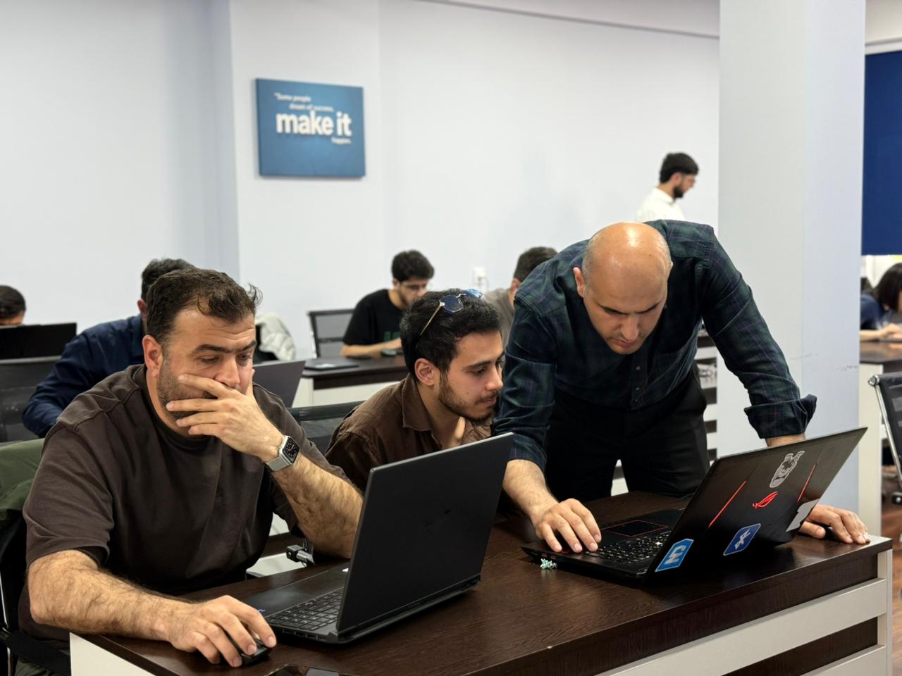 An Ingress Academy instructor supporting students during practical work